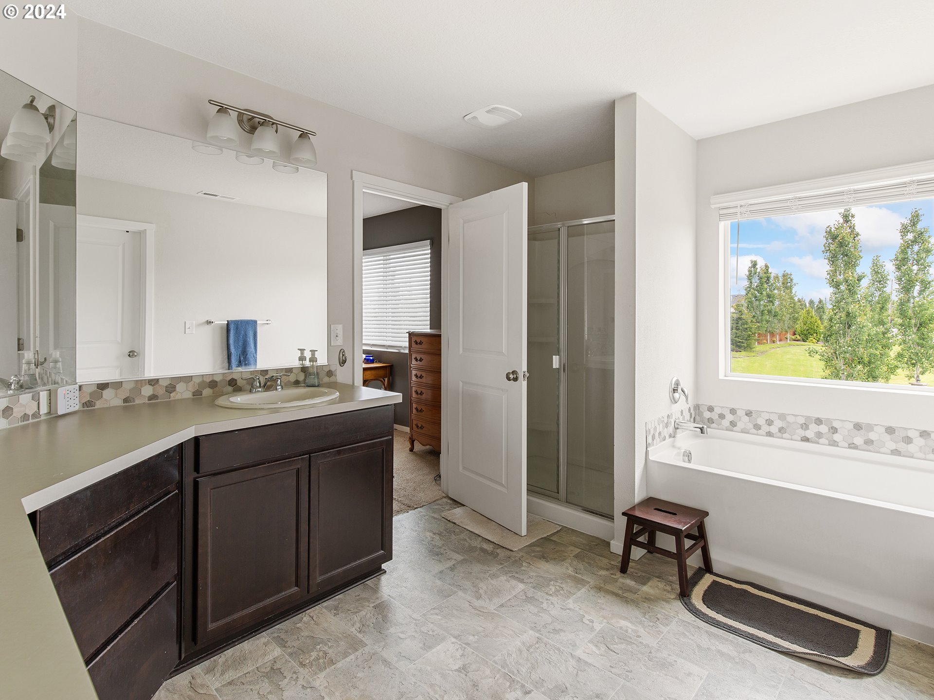 1928 South Robin Way Ridgefield, WA 98642 - Photo 18 of 27 a bathroom with a granite countertop sink and a bathtub