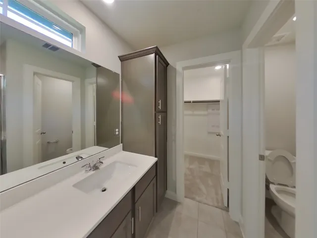 a bathroom with a double vanity sink mirror and shower