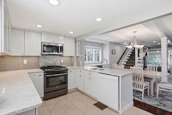 a kitchen with a sink stove and cabinets