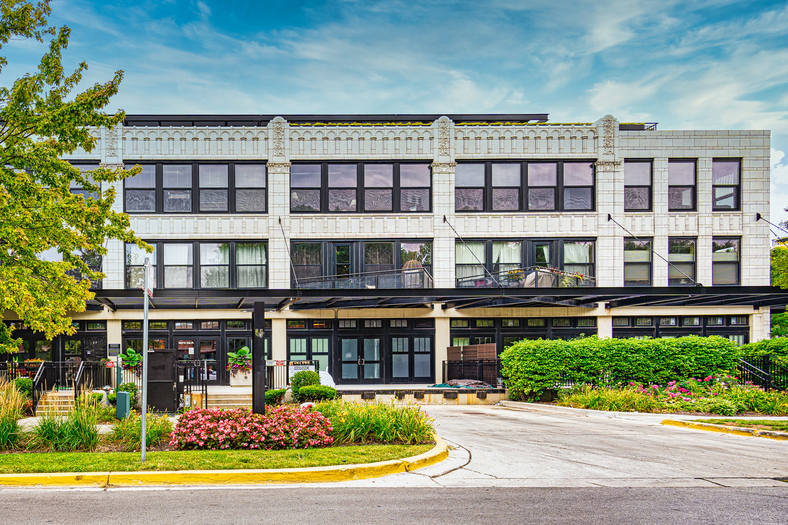 front view of a building with a garden