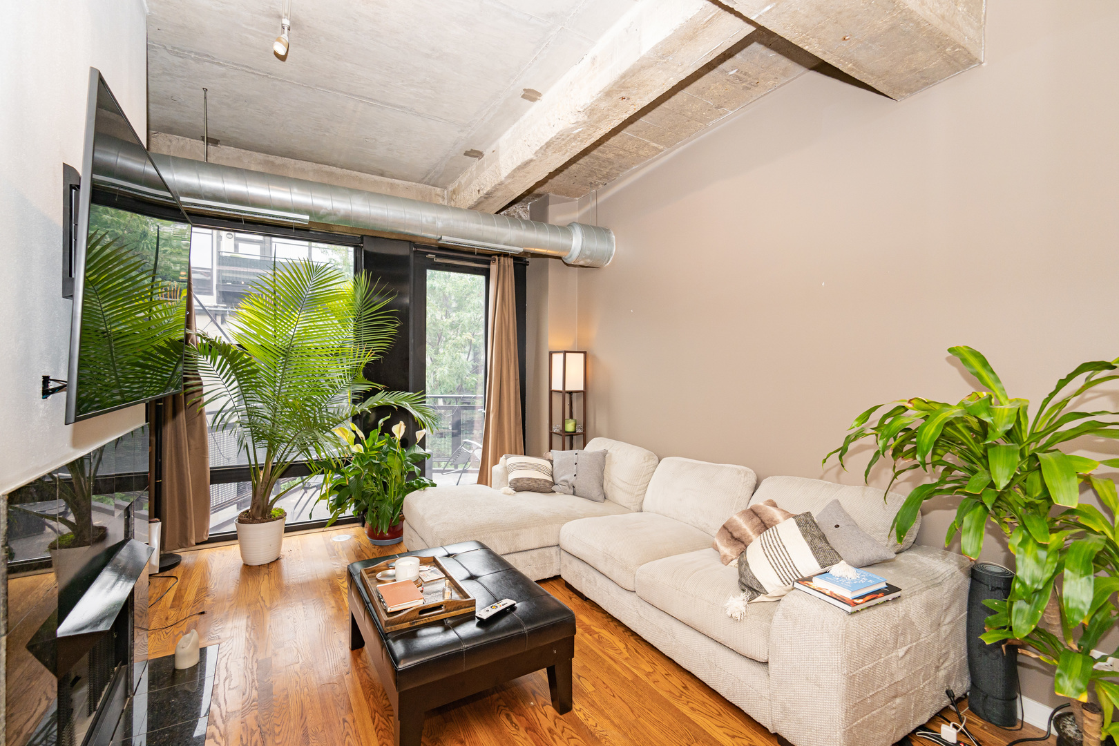 1069 West 14th Place, Unit 305 Chicago, IL 60608 - Photo 3 of 26 a living room with furniture and a large window