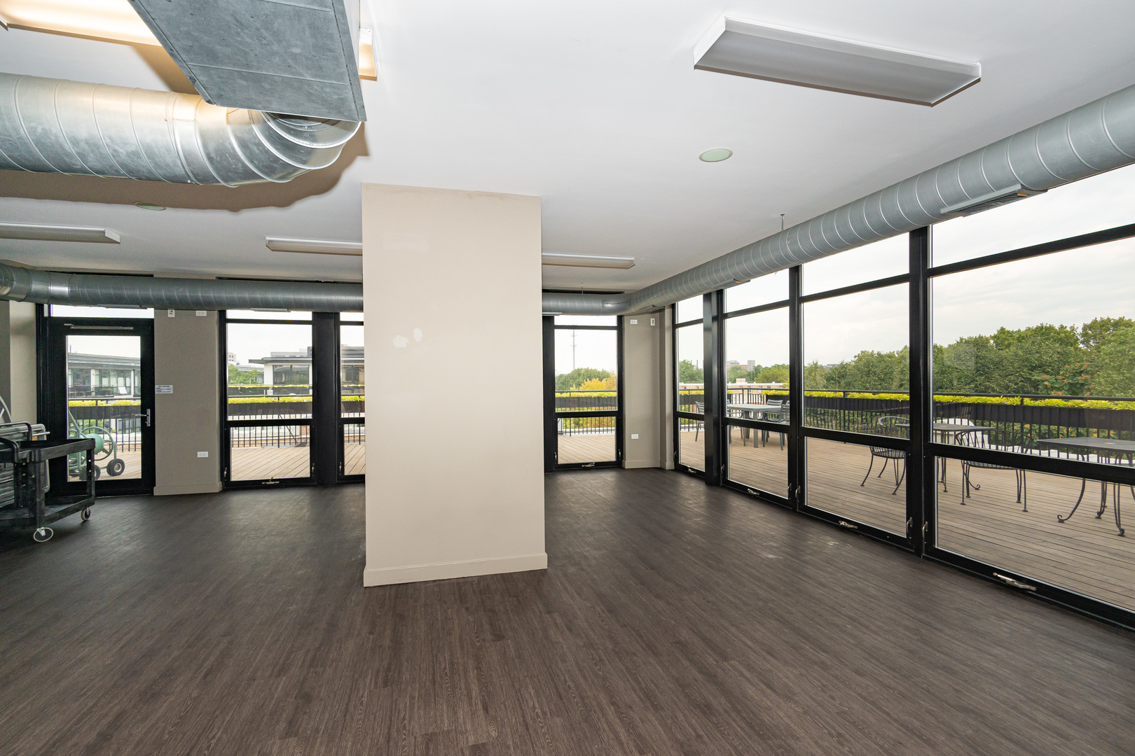 1069 West 14th Place, Unit 305 Chicago, IL 60608 - Photo 22 of 26 a view of an empty room with wooden floor and a window