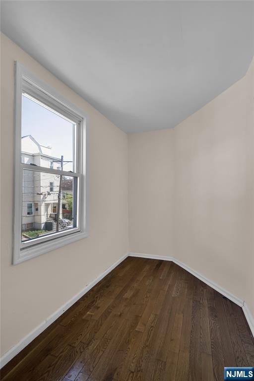 491 South 17th Street Newark, NJ 07103 - Photo 12 of 22 a view of an empty room with wooden floor and a window