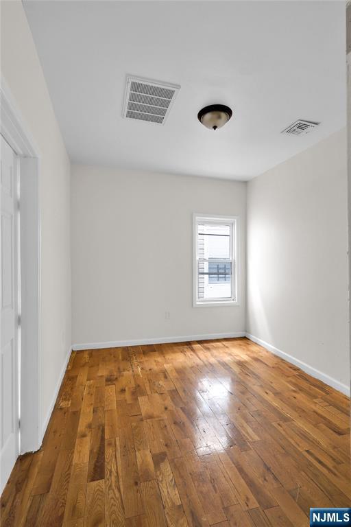 491 South 17th Street Newark, NJ 07103 - Photo 14 of 22 a view of empty room with wooden floor and fan