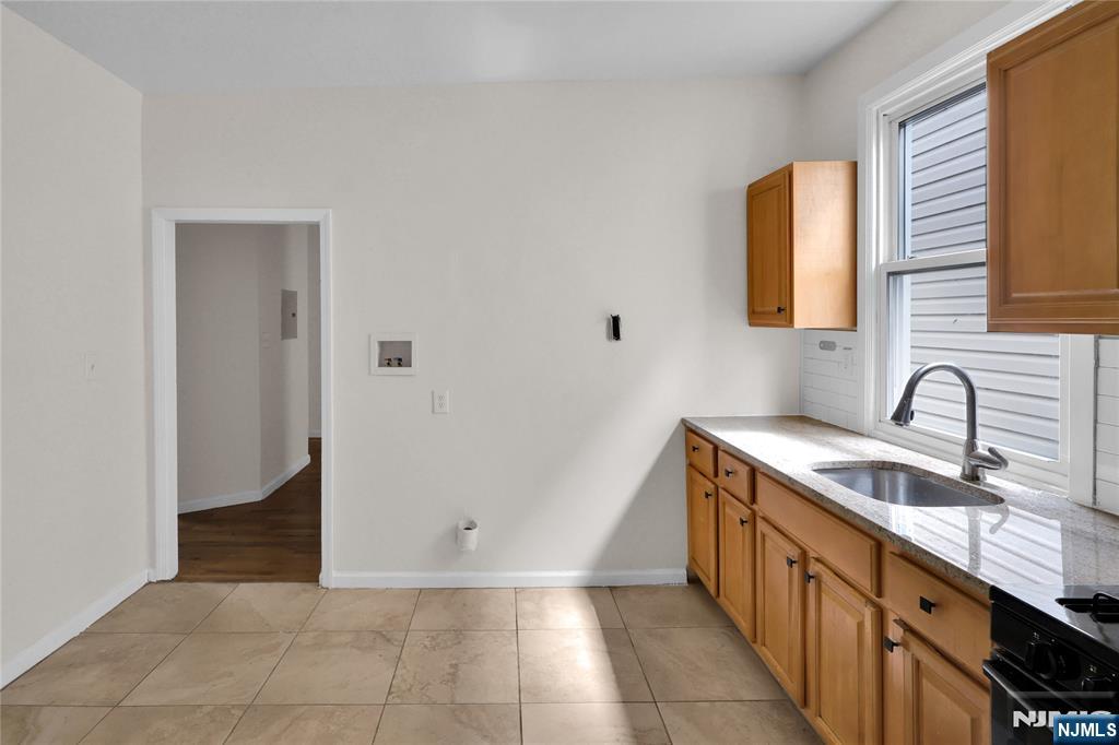 491 South 17th Street Newark, NJ 07103 - Photo 15 of 22 a kitchen with granite countertop a sink and a stove