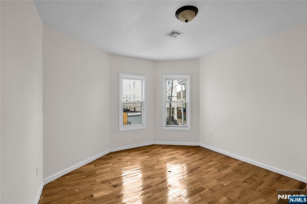 491 South 17th Street Newark, NJ 07103 - Photo 17 of 22 an empty room with a empty space and windows