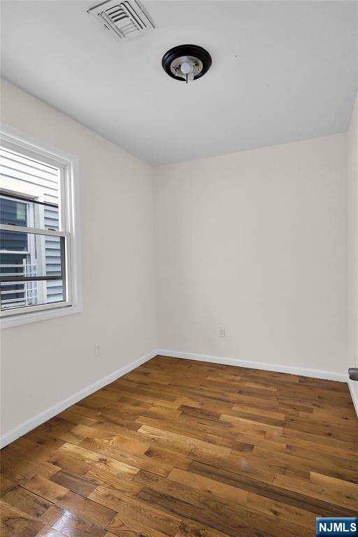 491 South 17th Street Newark, NJ 07103 - Photo 18 of 22 a view of an empty room with wooden floor and a window