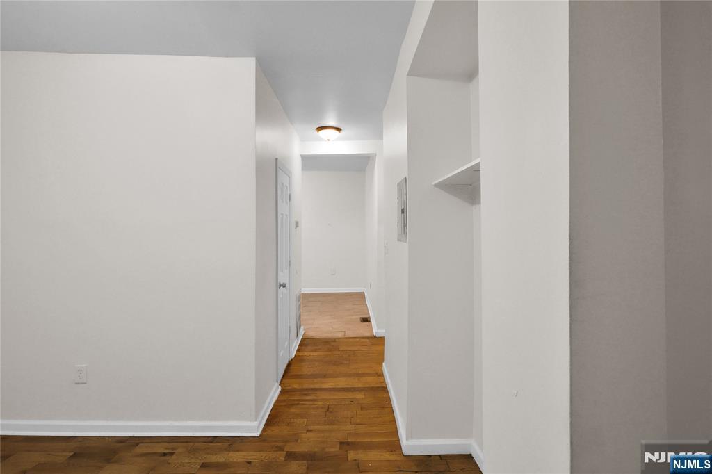491 South 17th Street Newark, NJ 07103 - Photo 3 of 22 a view of a hallway with wooden floor and a bathroom