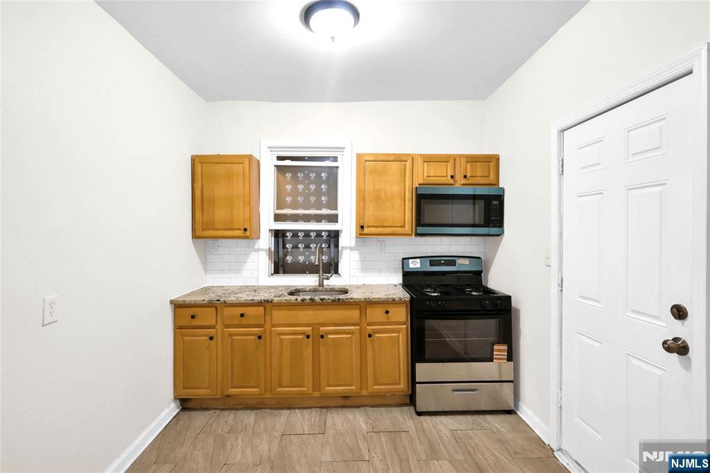 491 South 17th Street Newark, NJ 07103 - Photo 4 of 22 a kitchen with stainless steel appliances a stove microwave and refrigerator