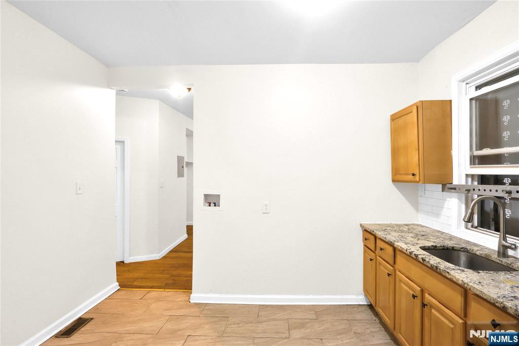 491 South 17th Street Newark, NJ 07103 - Photo 5 of 22 a bathroom with a granite countertop sink and a mirror