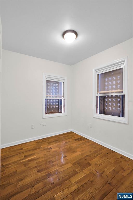 491 South 17th Street Newark, NJ 07103 - Photo 8 of 22 a view of an empty room with window and wooden floor