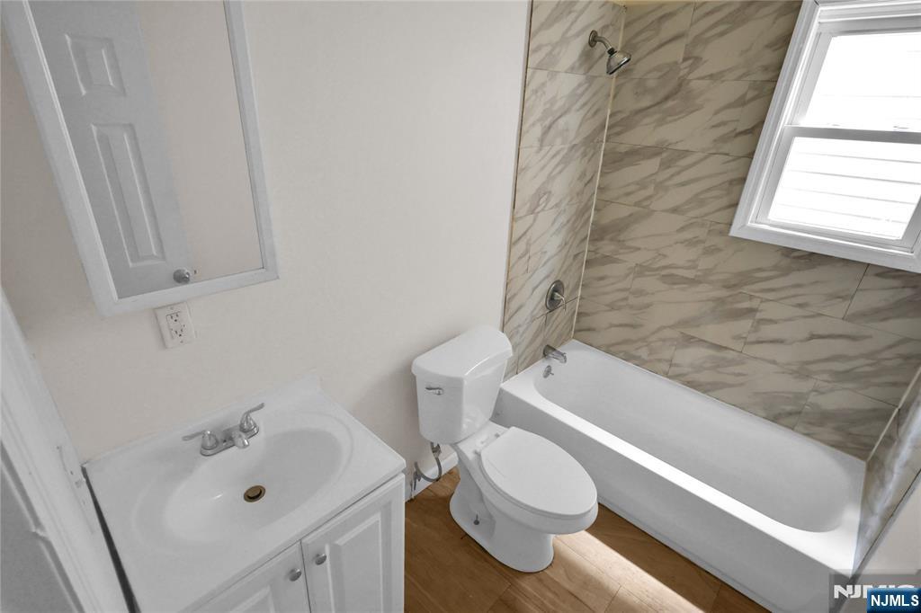 491 South 17th Street Newark, NJ 07103 - Photo 10 of 22 a bathroom with a sink and bathtub with toilet