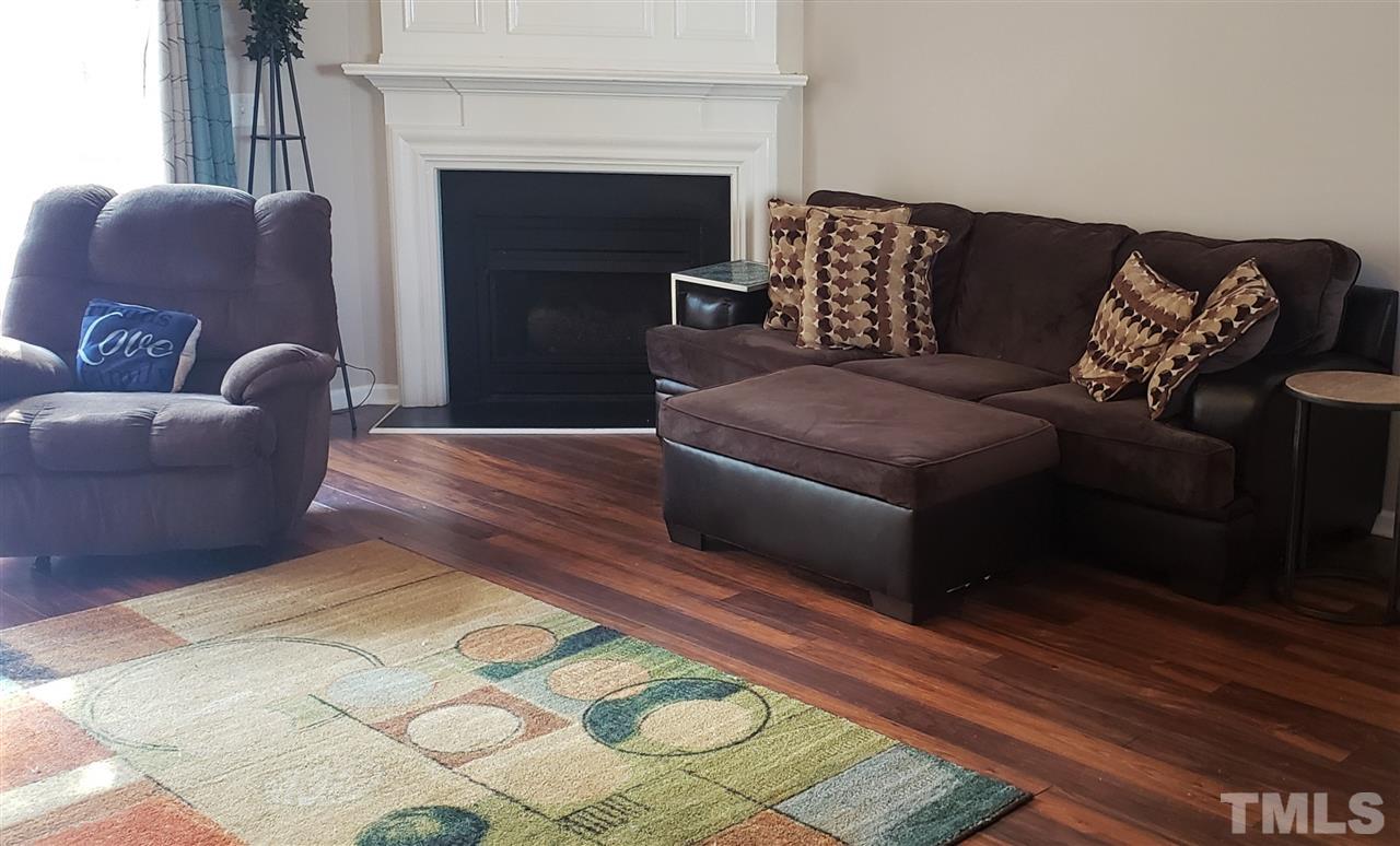 5321 Glen Canyon Road Raleigh, NC 27616 - Photo 2 of 3 a living room with furniture and a fireplace