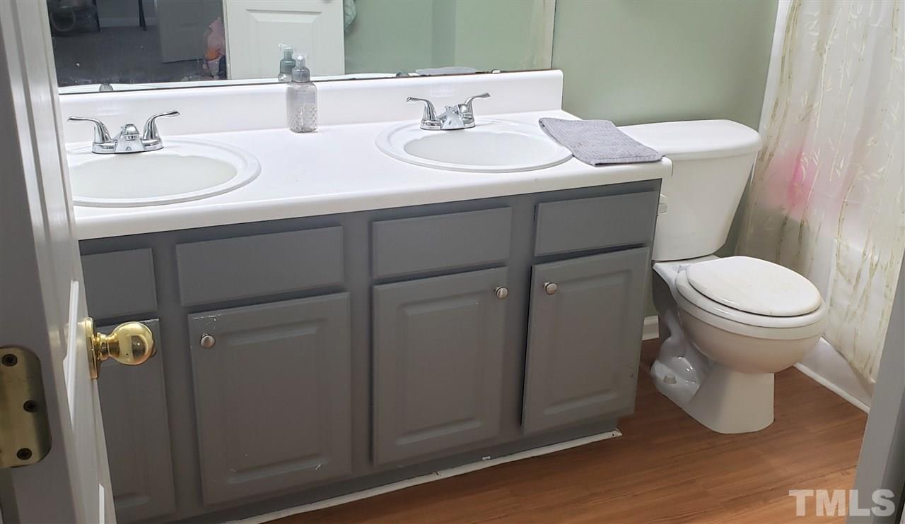 5321 Glen Canyon Road Raleigh, NC 27616 - Photo 3 of 3 a bathroom with a sink toilet and shower