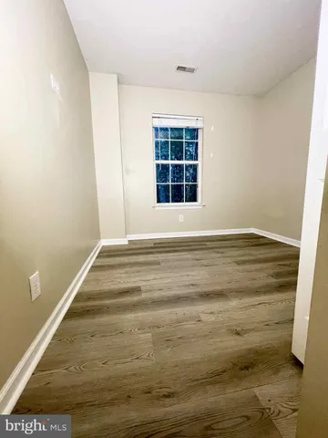 a view of wooden floor and windows in a room