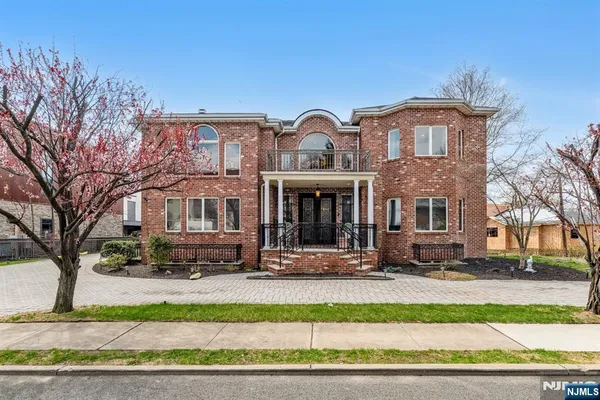 a front view of a building with a garden
