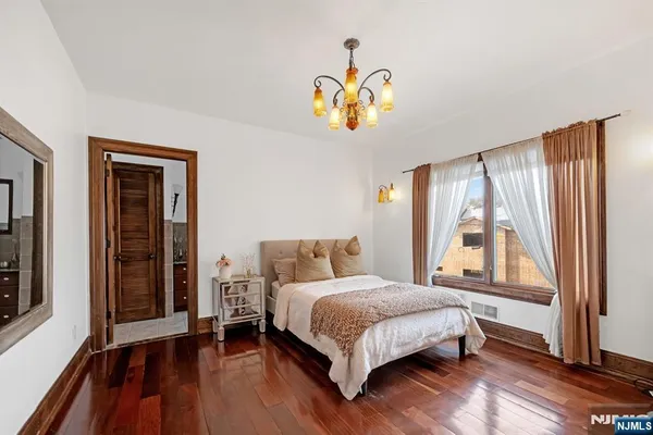 a bedroom with a bed and a chandelier