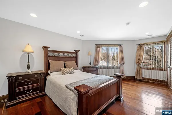 a bathroom with a granite countertop sink a toilet and shower