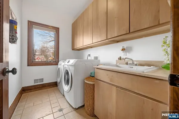 a large kitchen with a table and chairs
