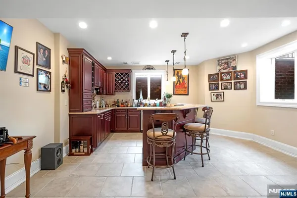 a living room with furniture a large window and a dining table