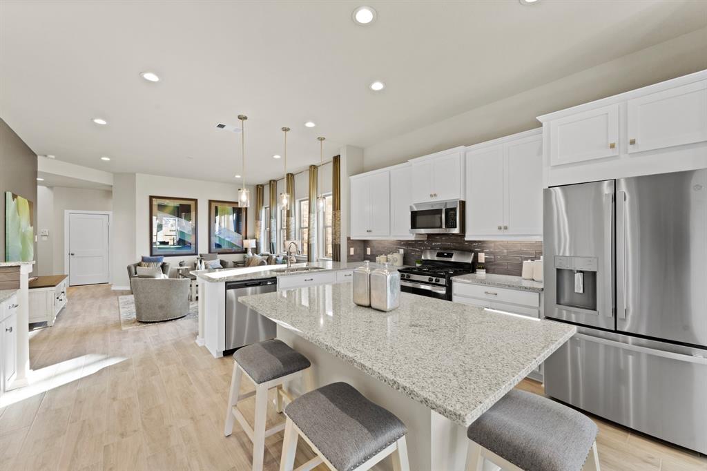 a kitchen with a sink a counter top stainless steel appliances and cabinets
