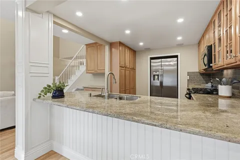 a kitchen with sink refrigerator and stove