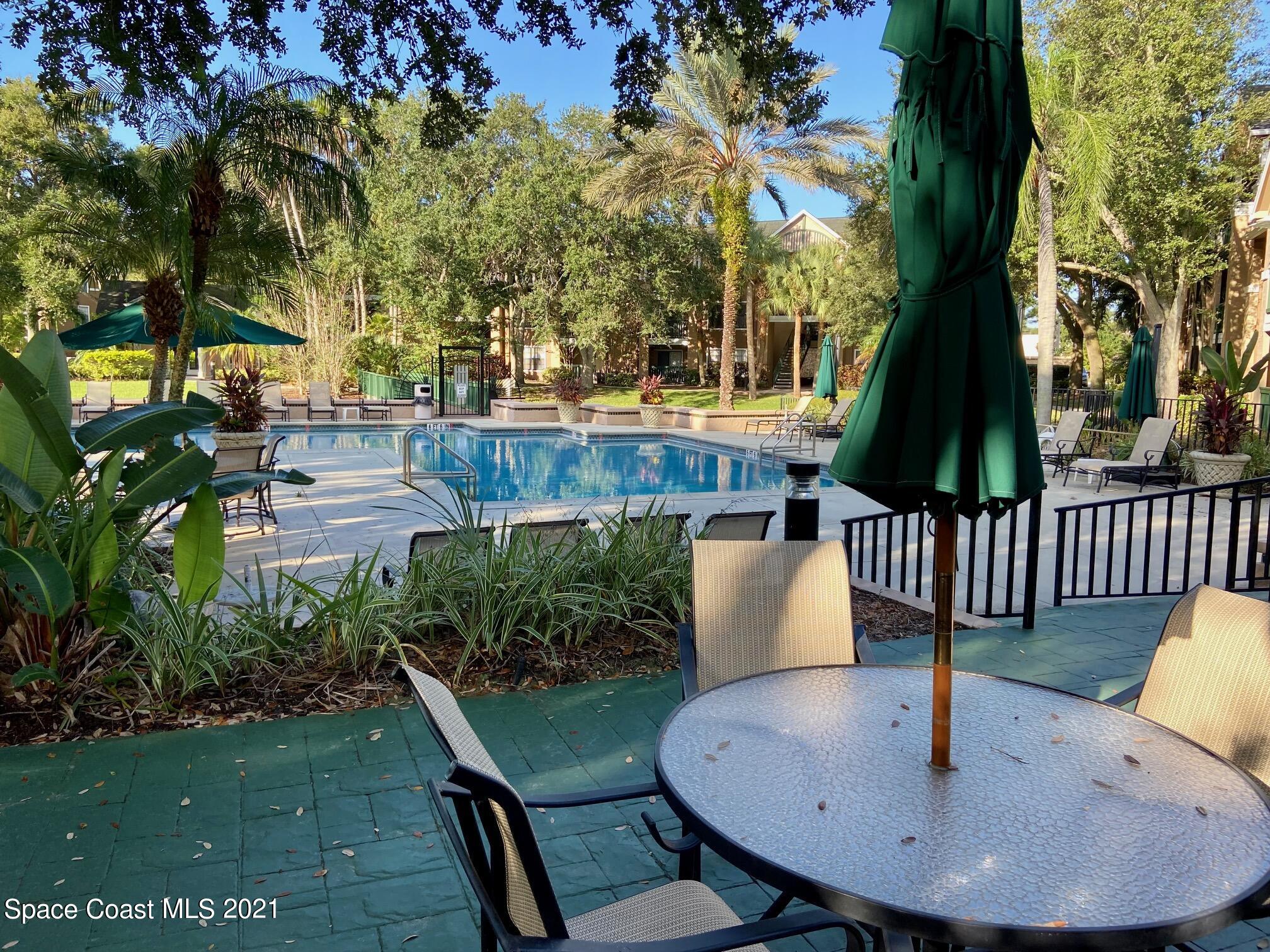 7667 North Wickham Road, Unit # 414 Melbourne, FL 32940 - Photo 15 of 24 Seating Overlooking Pool