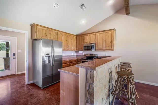 a view of a kitchen with a sink and a refrigerator