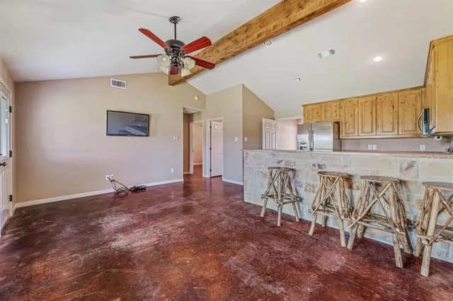 an empty room with a window and ceiling fan