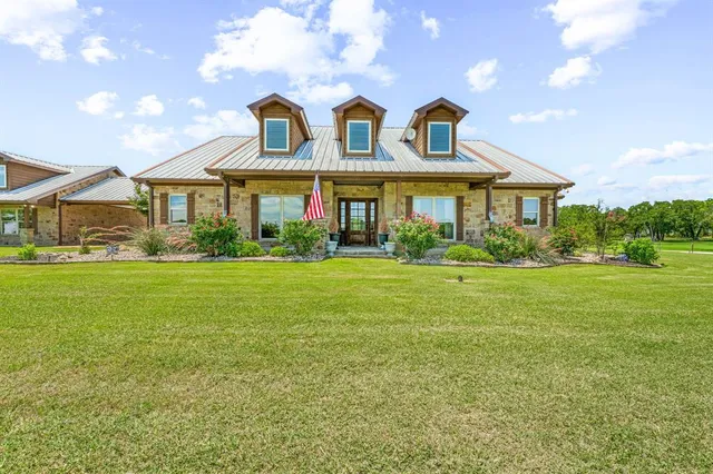 a front view of house with yard and green space