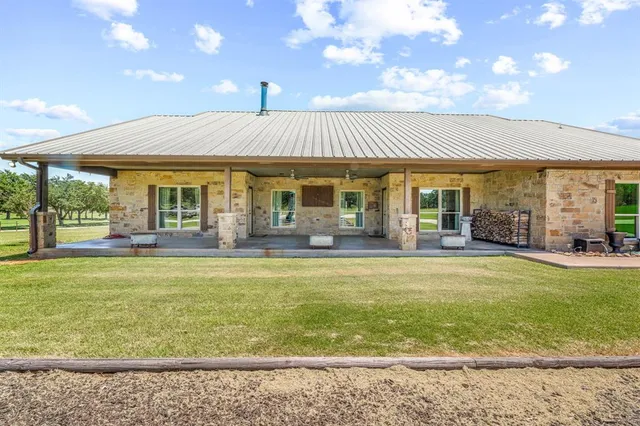 a front view of house with yard and entertaining space