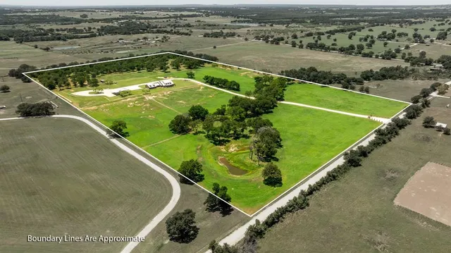 a view of a hallway with wooden floor and a chandelier