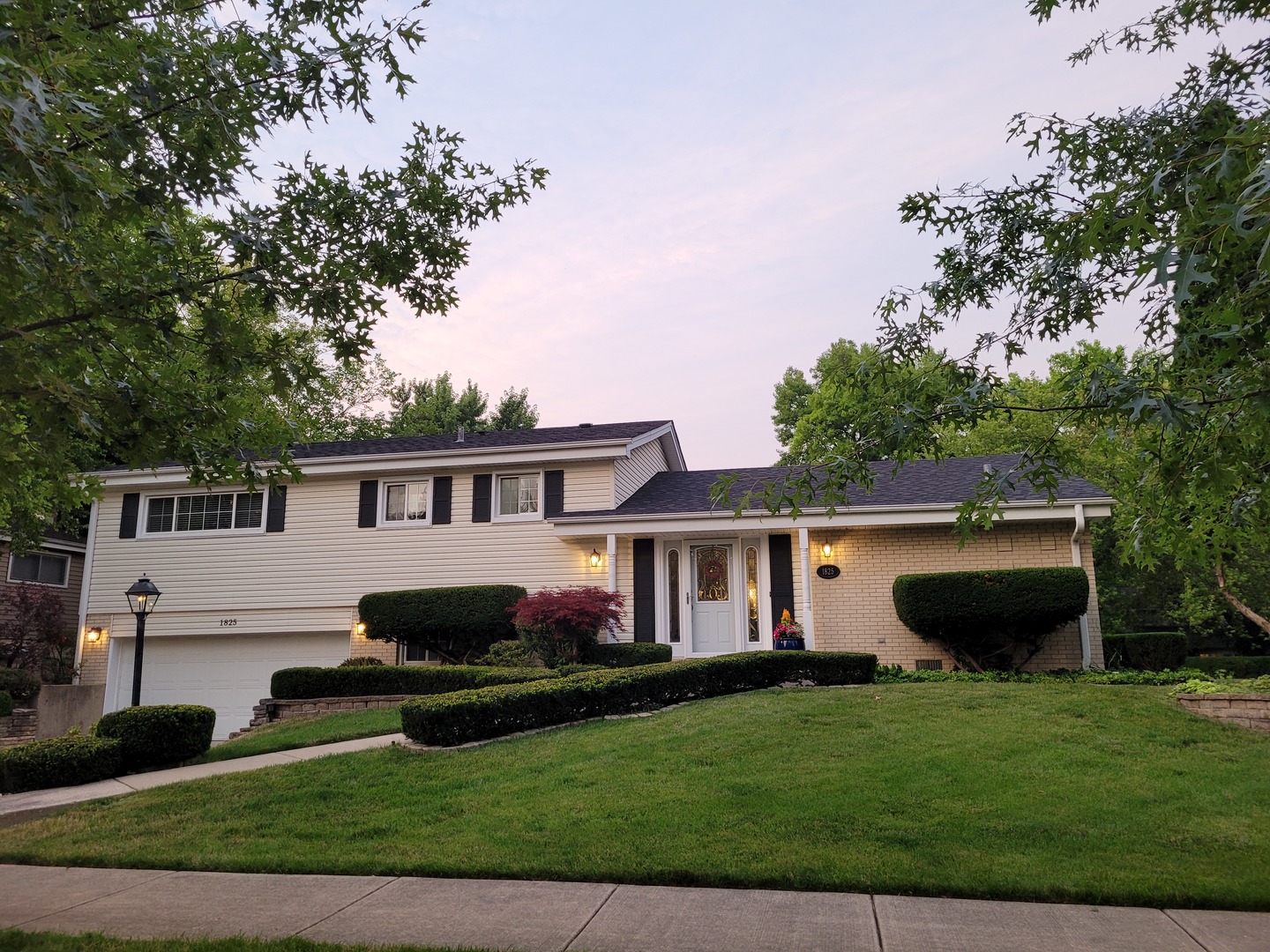 1825 Barberry Road Northbrook, IL 60062 - Photo 1 of 24 a front view of a house with a garden and yard