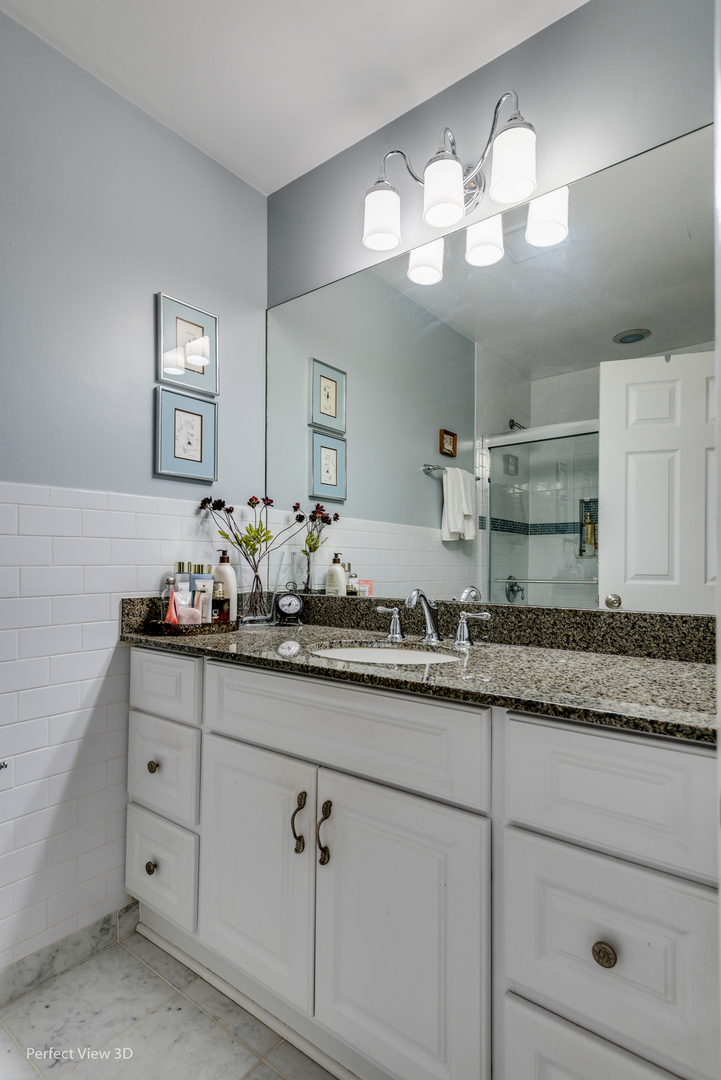 1825 Barberry Road Northbrook, IL 60062 - Photo 16 of 24 a bathroom with double sink and a mirror