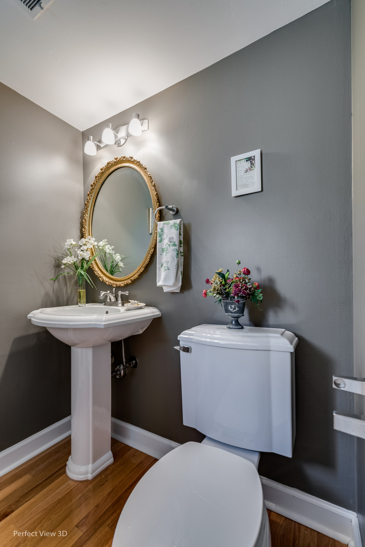 1825 Barberry Road Northbrook, IL 60062 - Photo 7 of 24 a bathroom with a toilet sink and mirror