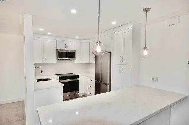 a kitchen with a refrigerator a sink and microwave