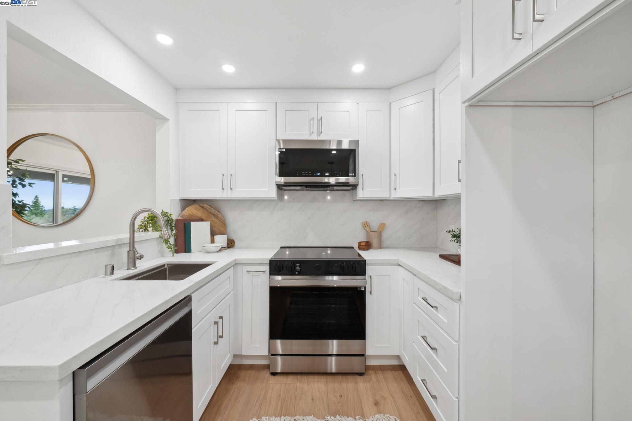 4033 Terra Granada Drive, Unit 5C Walnut Creek, CA 94595 - Photo 16 of 44 a kitchen with a sink and a stove top oven