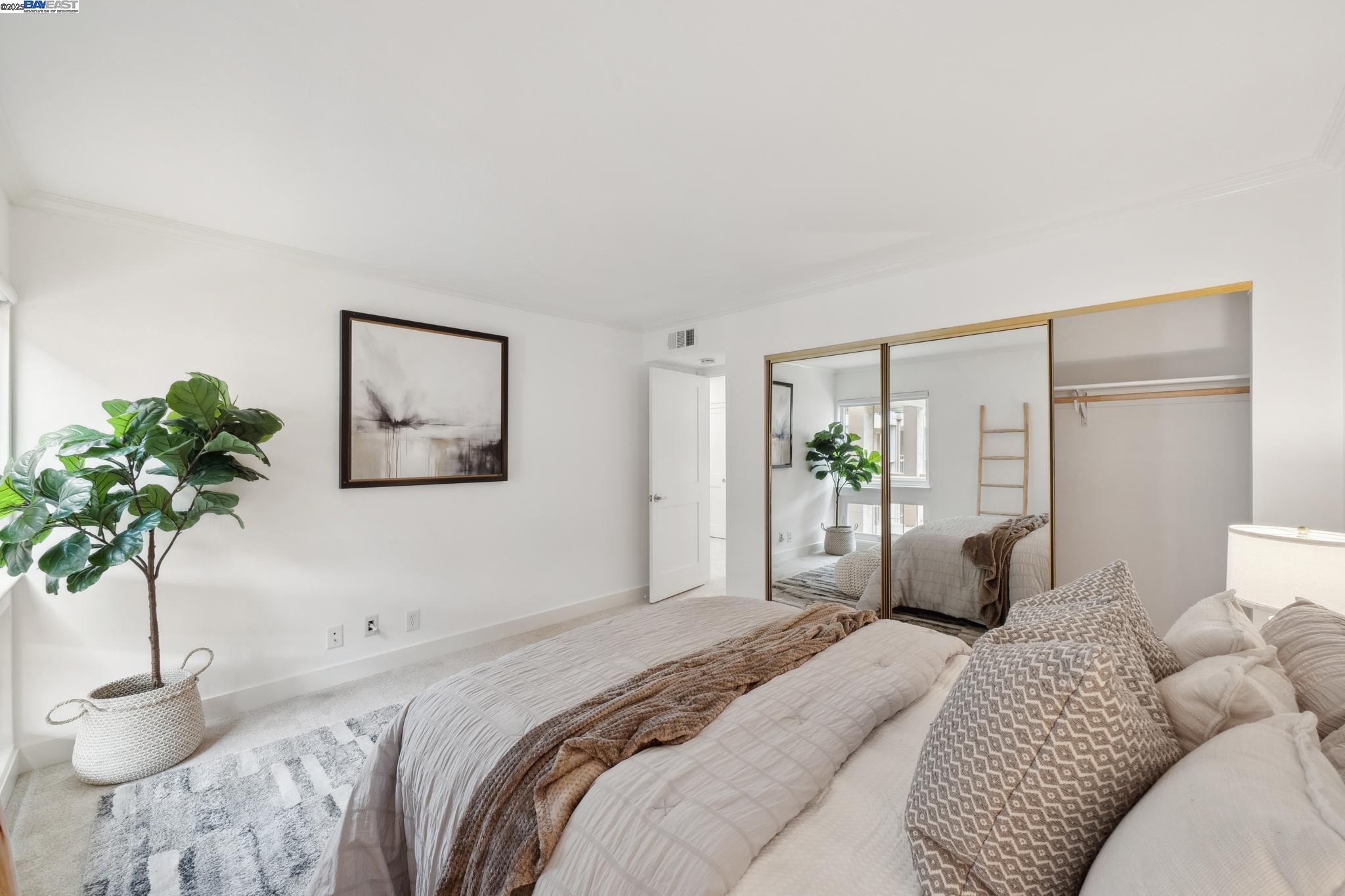 4033 Terra Granada Drive, Unit 5C Walnut Creek, CA 94595 - Photo 22 of 44 a bedroom with a large bed and a potted plant