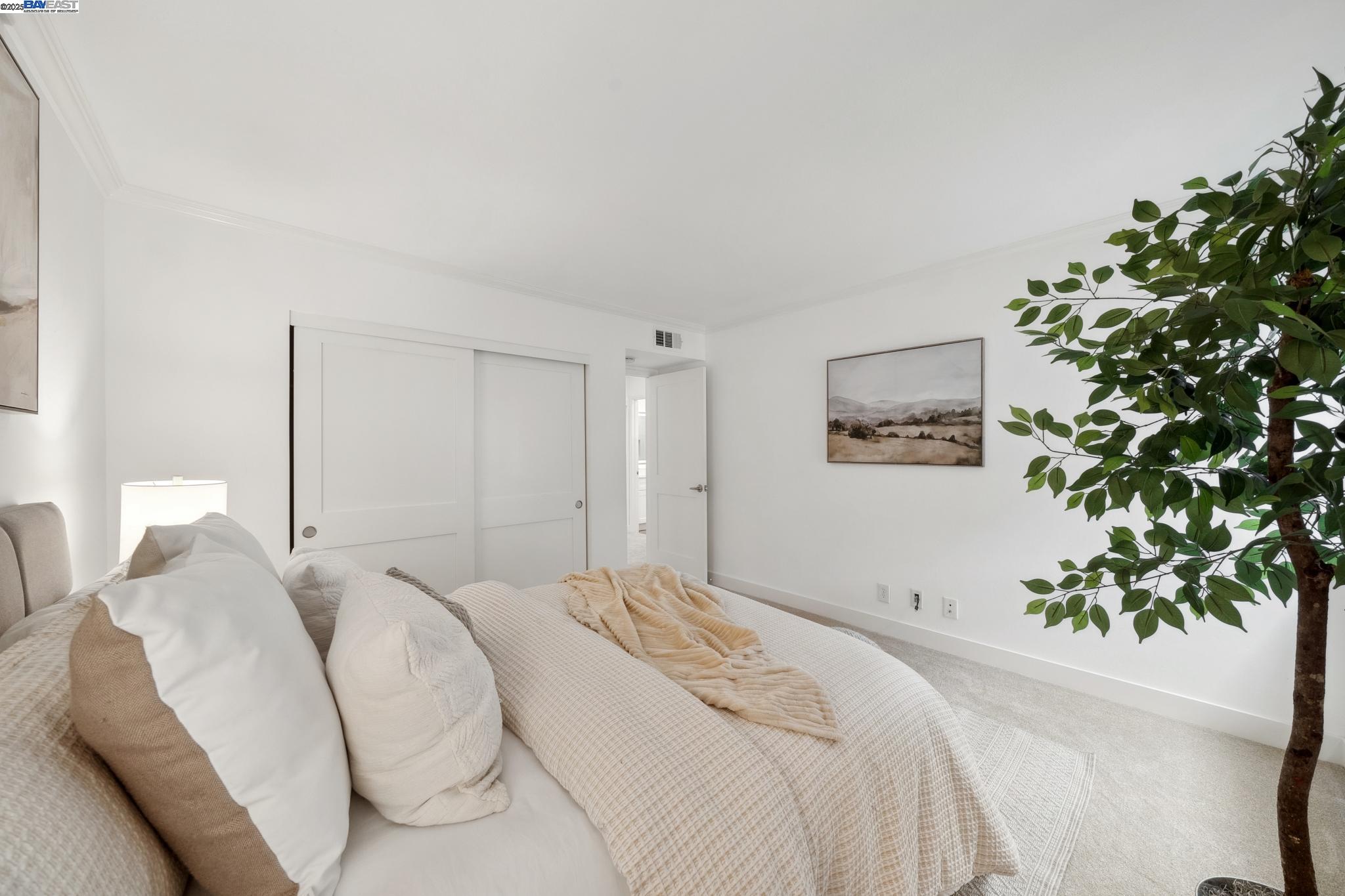 4033 Terra Granada Drive, Unit 5C Walnut Creek, CA 94595 - Photo 26 of 44 a bedroom with a large bed and a potted plant