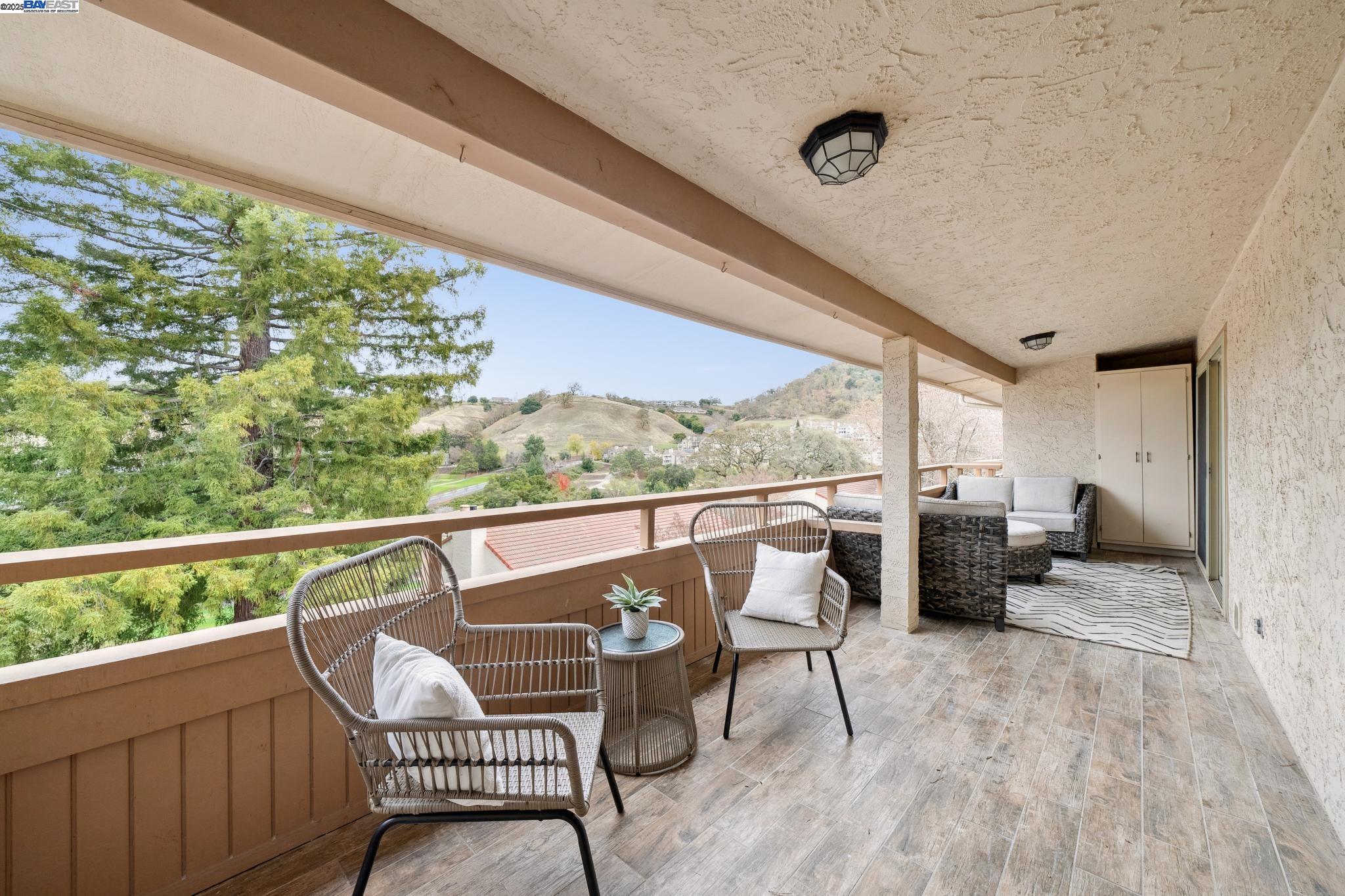 4033 Terra Granada Drive, Unit 5C Walnut Creek, CA 94595 - Photo 28 of 44 a balcony with wooden floor and outdoor seating
