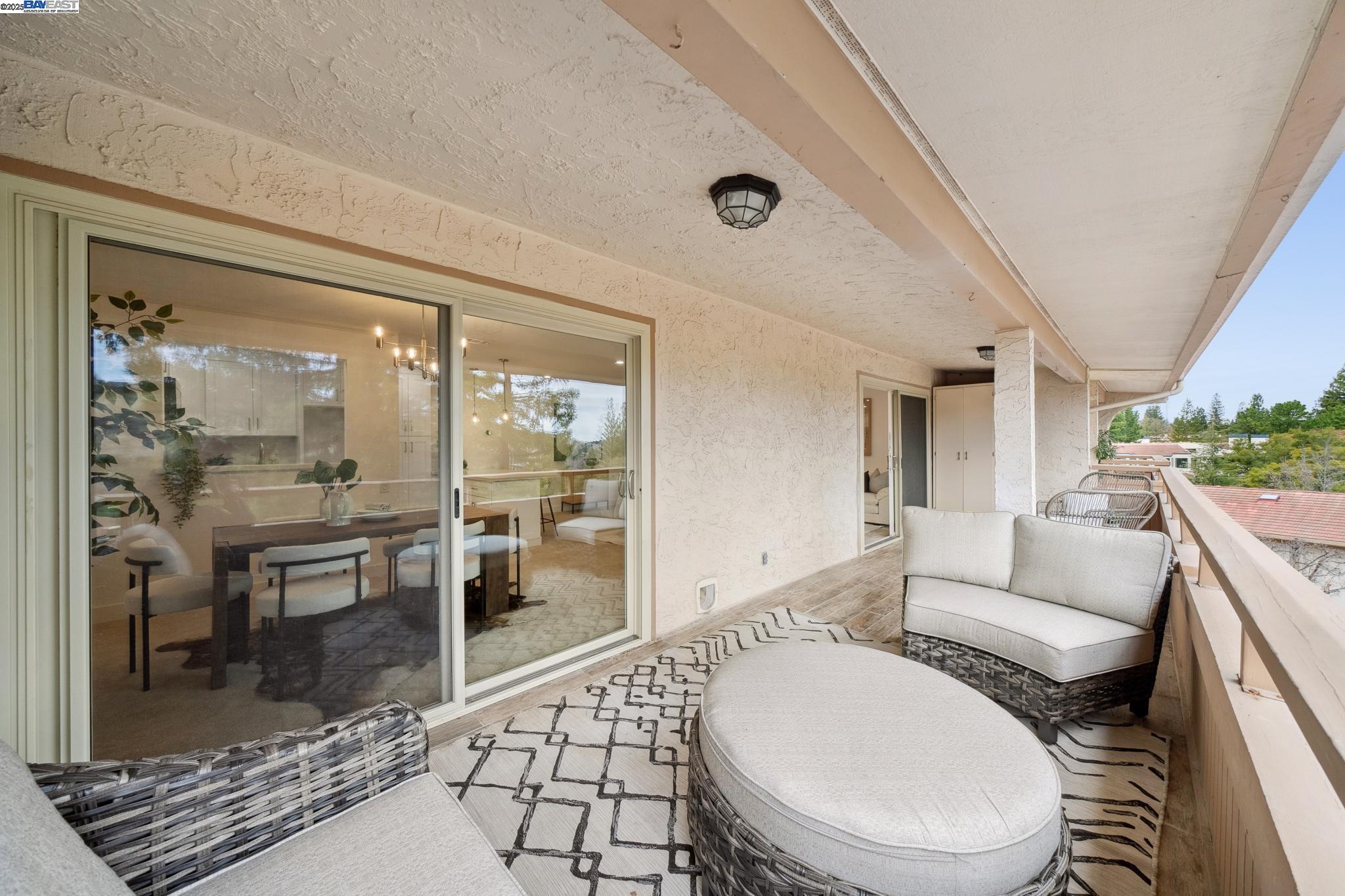 4033 Terra Granada Drive, Unit 5C Walnut Creek, CA 94595 - Photo 32 of 44 a living room with a couch and wooden floor