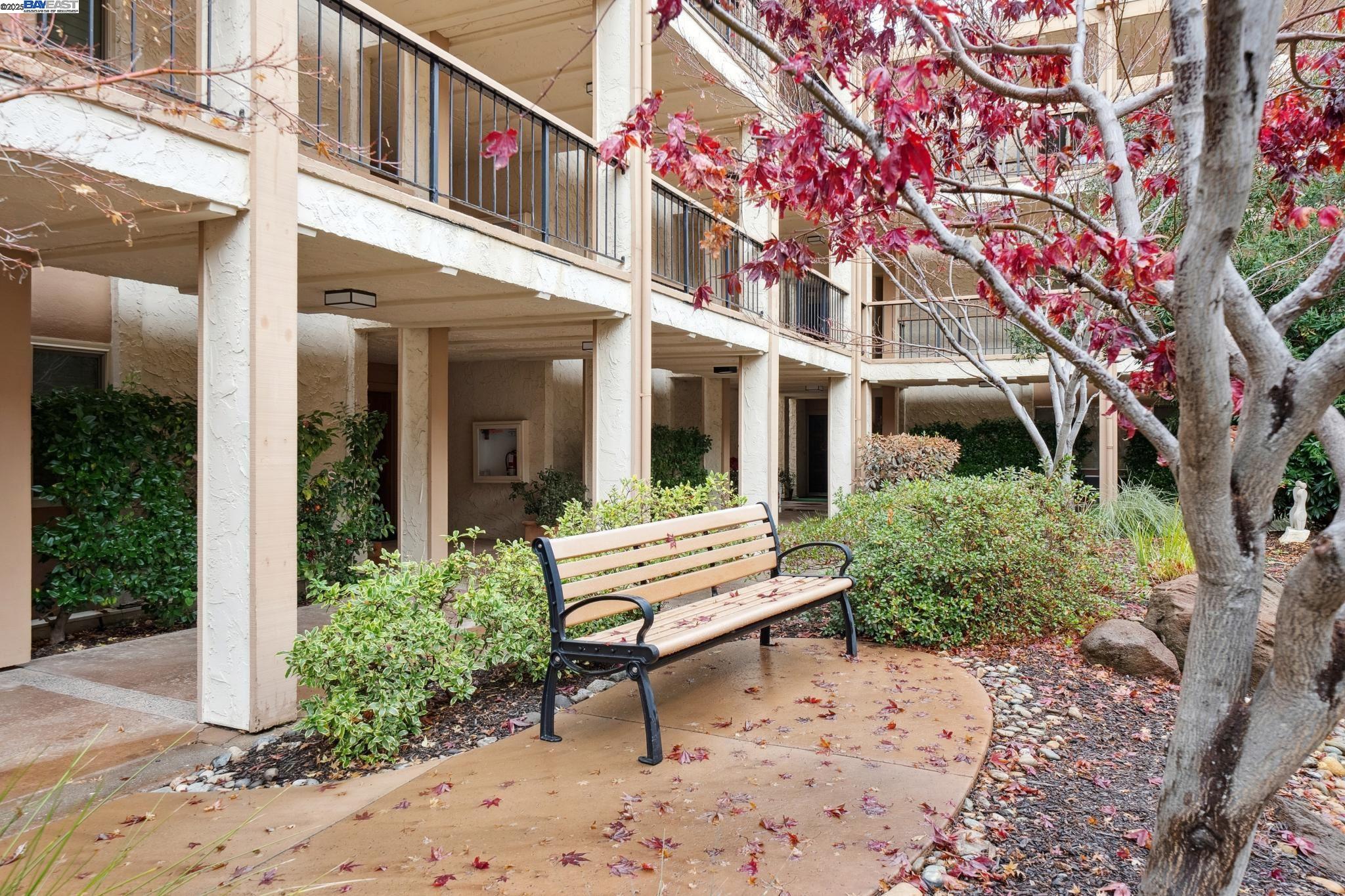 4033 Terra Granada Drive, Unit 5C Walnut Creek, CA 94595 - Photo 43 of 44 a front view of a building with garden and sitting area