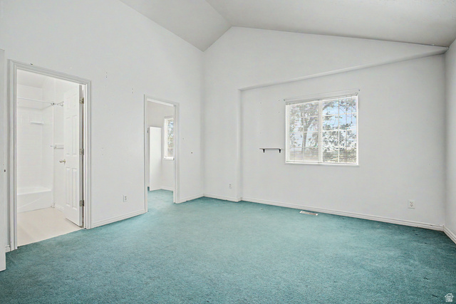 2058 California Avenue, Unit 2 Provo, UT 84606 - Photo 7 of 32 Bright room featuring vaulted ceilings, a large window, teal carpeting, and white painted walls