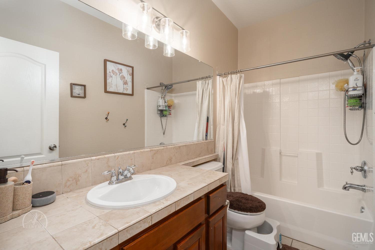 Undisclosed Address Bakersfield, CA 93312 - Photo 11 of 20 a bathroom with a sink a toilet and shower