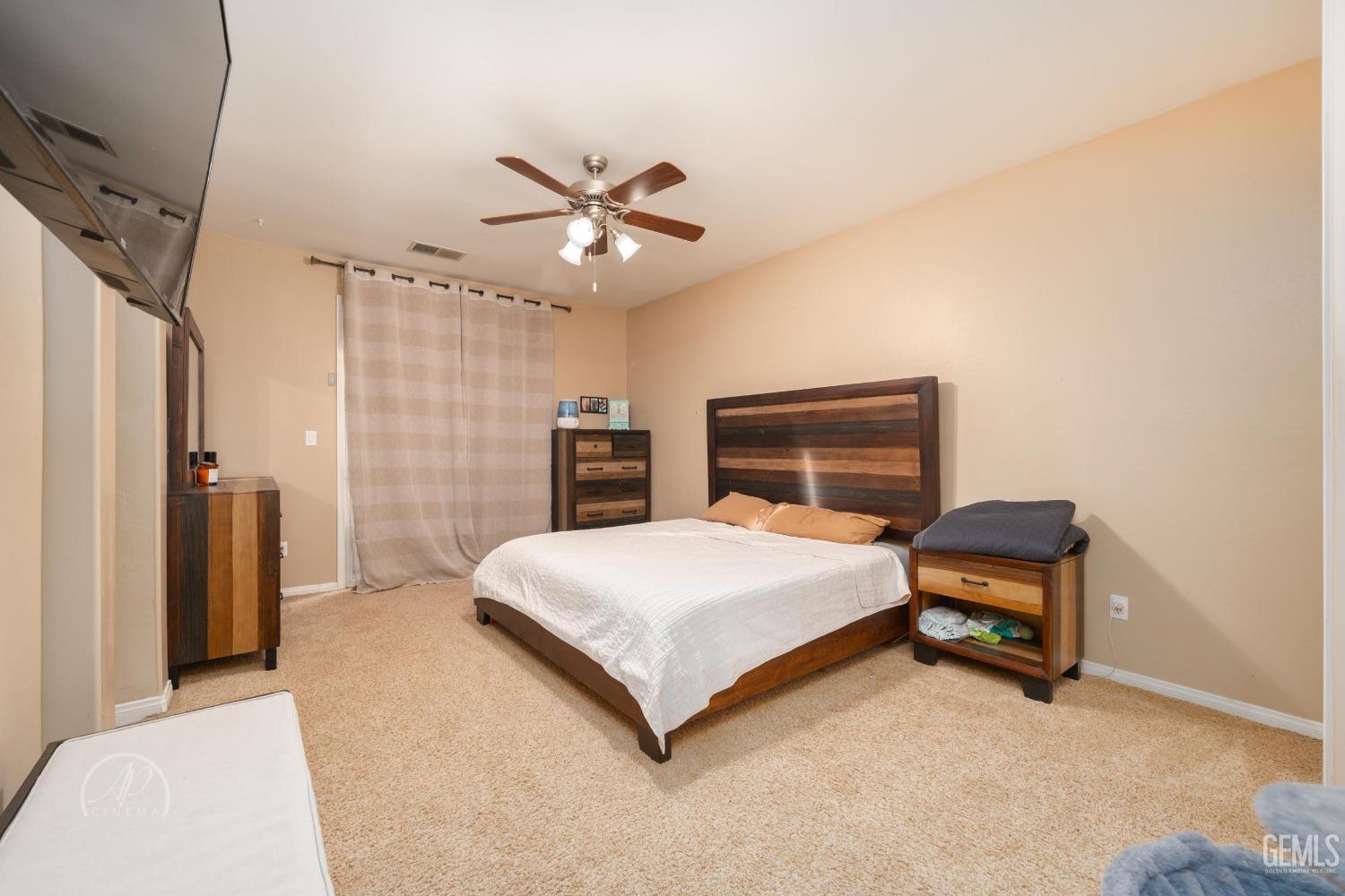 Undisclosed Address Bakersfield, CA 93312 - Photo 14 of 20 a bedroom with a bed and a chandelier