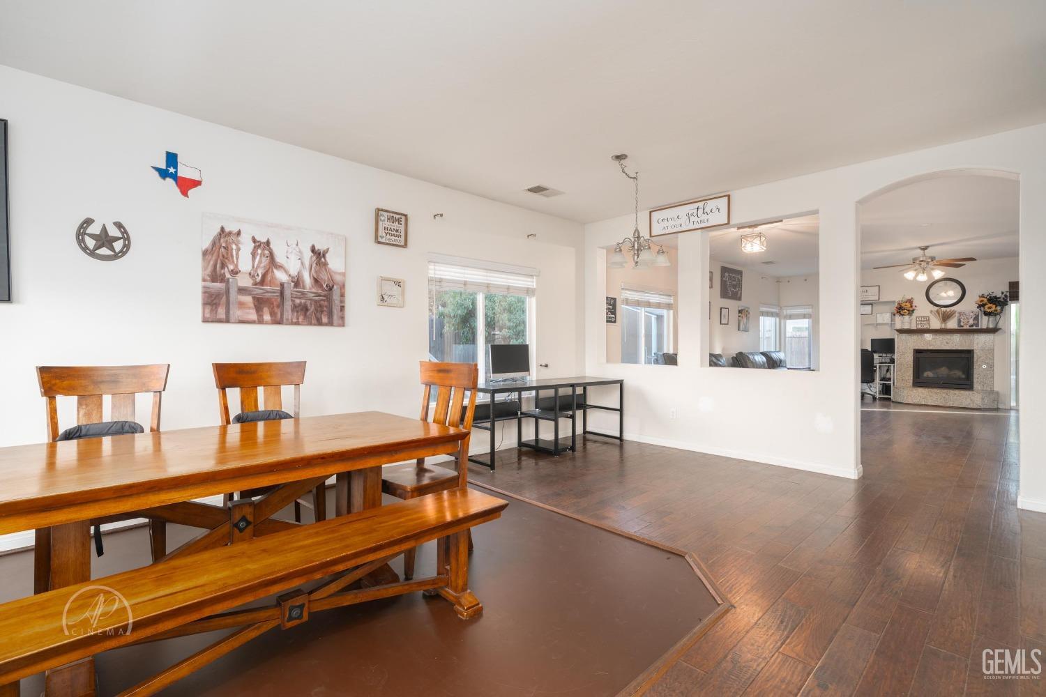 Undisclosed Address Bakersfield, CA 93312 - Photo 4 of 20 a living room with furniture and kitchen view with wooden floor