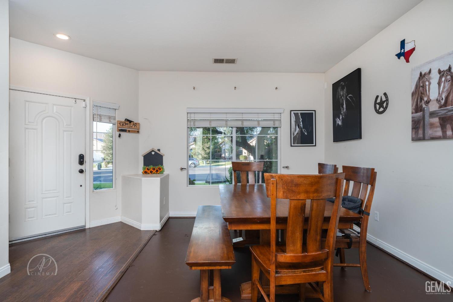Undisclosed Address Bakersfield, CA 93312 - Photo 5 of 20 a view of a dining room with furniture and wooden floor