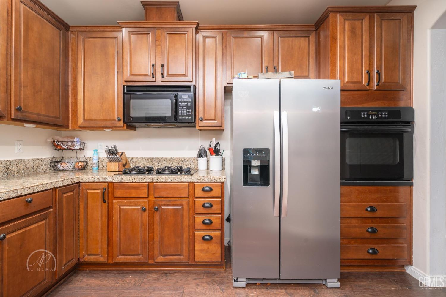 Undisclosed Address Bakersfield, CA 93312 - Photo 9 of 20 a kitchen with granite countertop a refrigerator and a stove
