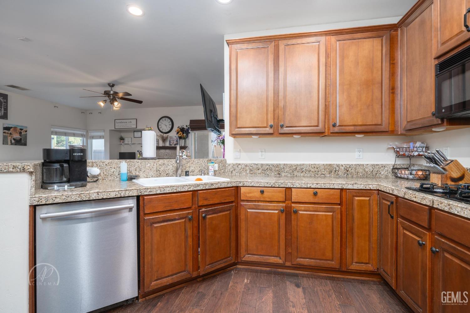 Undisclosed Address Bakersfield, CA 93312 - Photo 10 of 20 a kitchen with stainless steel appliances granite countertop a sink stove and cabinets