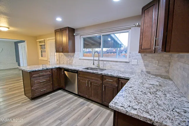 a kitchen with granite countertop wooden cabinets and a granite counter tops